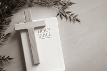 wood cross on a white Bible 