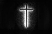 illuminated glowing cross on a church wall 