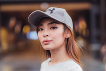 a young woman in a ball cap 