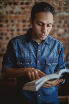 Latino man reading a Bible 