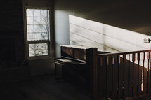window and shadows over dusty piano