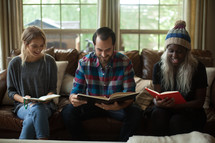 man and women reading Bibles at a fall Bible study 