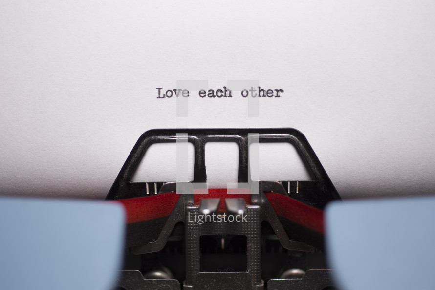 words love each other typed on a typewriter 