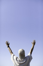 a man with raised hands outdoors 