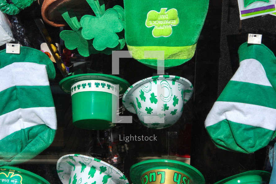 a collection of st. patricks day party hats in window