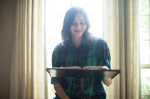 A young woman leading a Bible study.