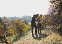 a family hugging on a vineyard hillside 
