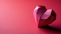 Paper origami heart on red background. Valentine's day concept.