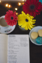 gerber daisies and journal with cookies and coffee 