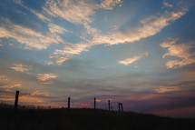 fence line and sky at sunset 