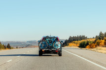 Car with bikes on the road in the fall