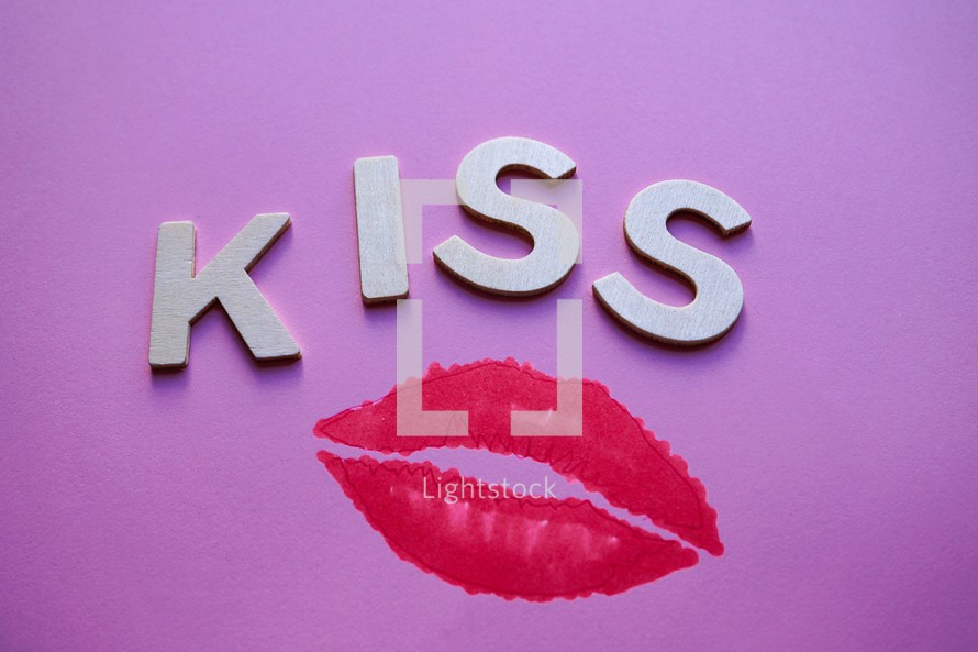 kiss word  and lips on the pink background