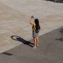 people on the street taking photos with a smartphone in Bilbao city, spain