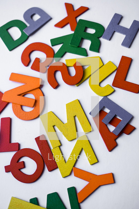 multicolored wooden letters on the white background