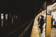 A woman waits for the subway in New York City