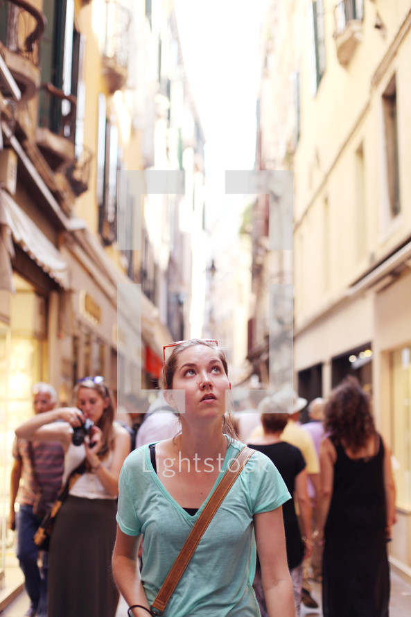tourists walking in a narrow alley in Venice 