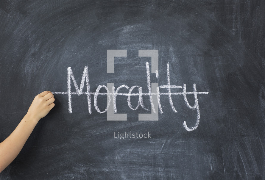 crossing through the word morality off a chalkboard 