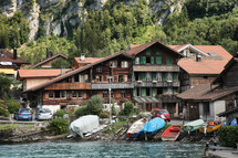 boats on a shore and houses 