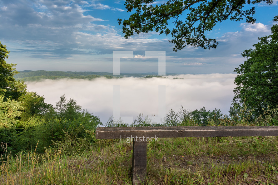 bench on a mountaintop and dense fog 