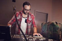 a man in a studio on a sound board 