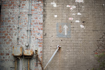 Brick walls with an arrow pointing up.