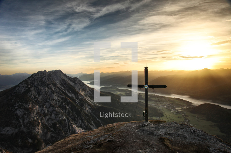 cross on a mountain top at sunrise 
