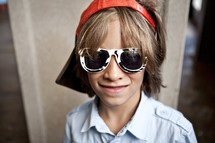 Boy wearing sunglasses and visor