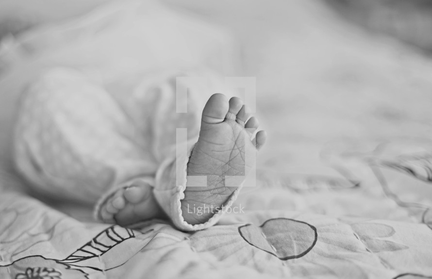 An infants bare feet. 