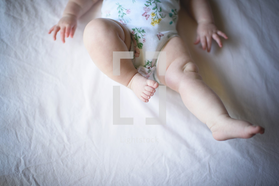 an infant's chubby legs 