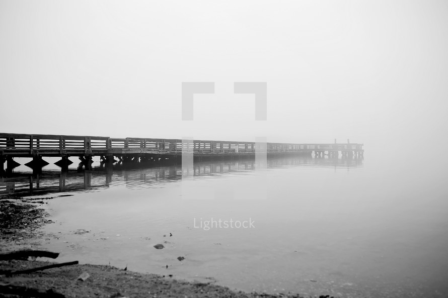 lake pier in fog 