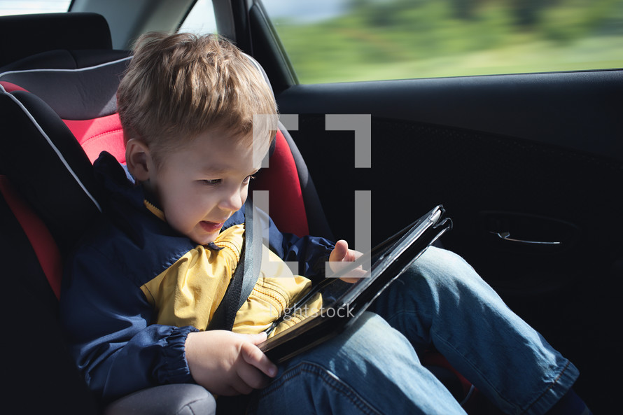 Child in the car with tablet PC
