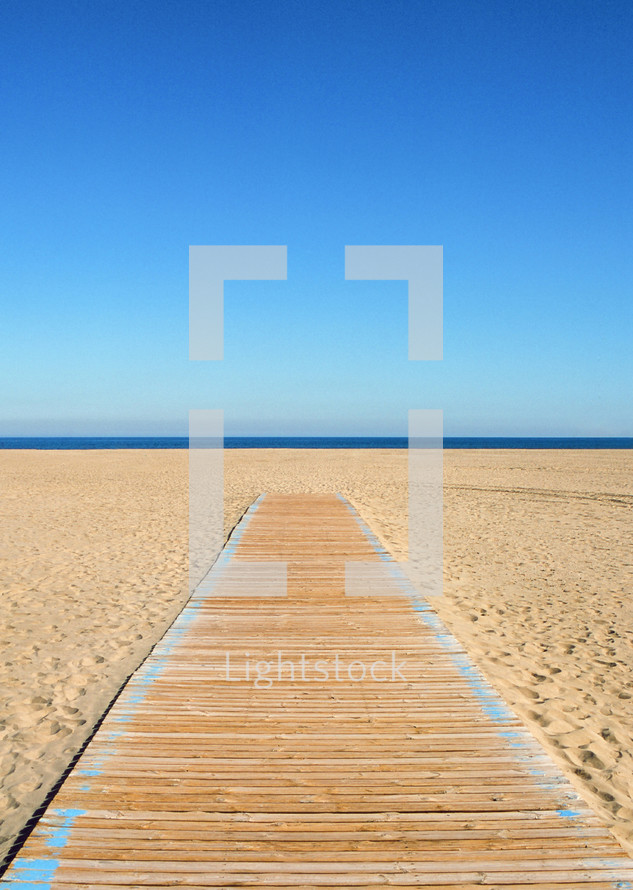 Empty beach and wooden path