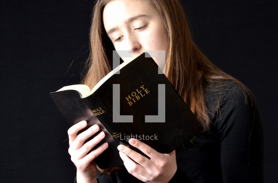 teen girl reading a Bible t