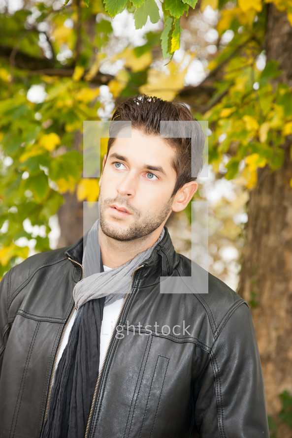 man standing outdoors in a leather jacket 
