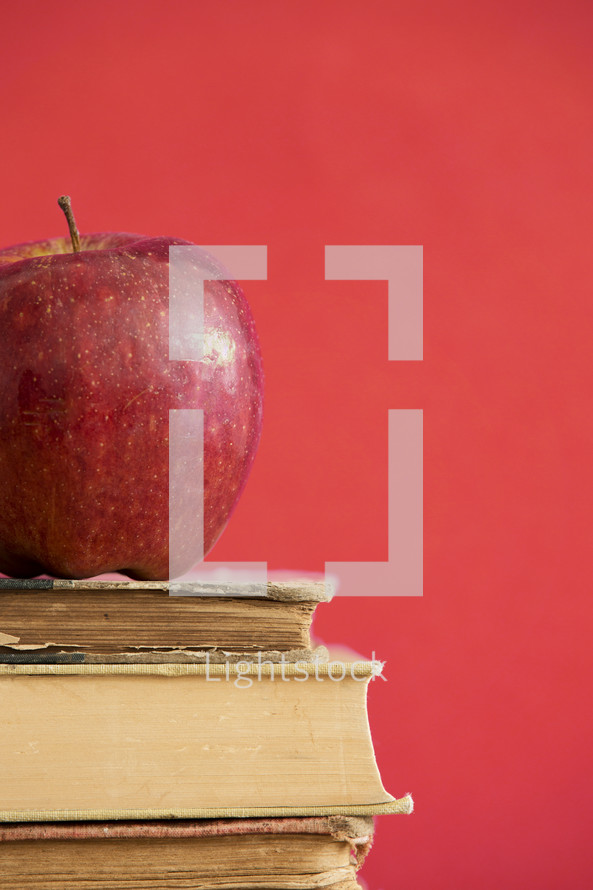 an apple on a stack of books 