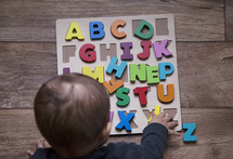 infant with an Alphabet puzzle 
