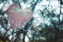 a heart doily in a tree