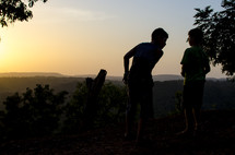 kids on a mountaintop at sunset 