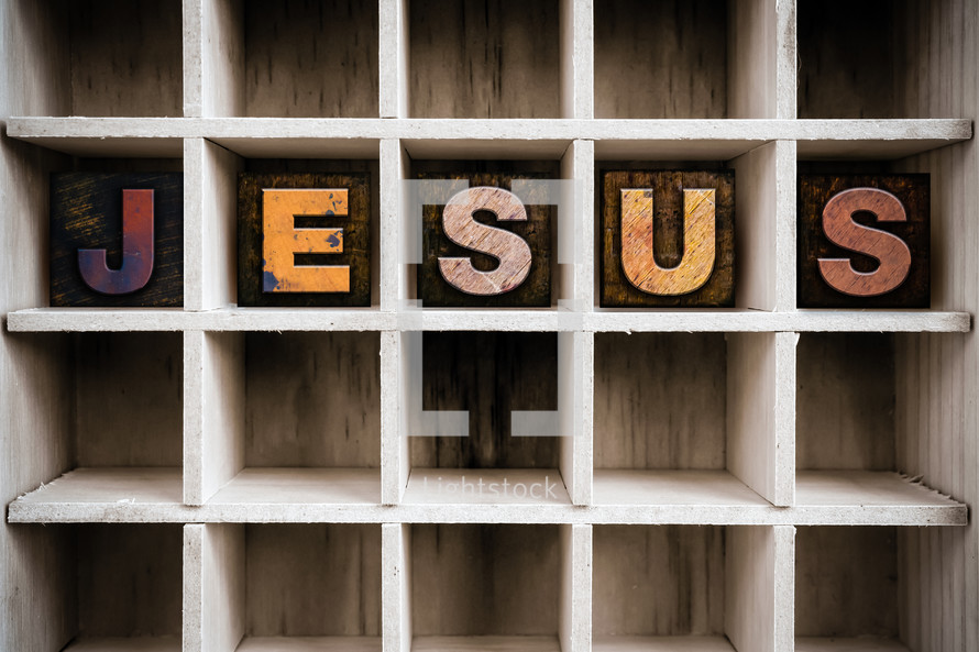 word Jesus on a wood shelf 