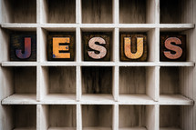 word Jesus on a wood shelf 