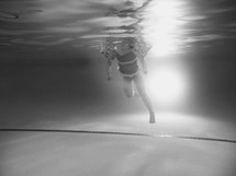 child swimming under water 