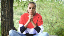 a young woman in prayer 