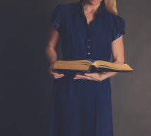 torso of a woman reading a Bible 