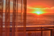 sunset through curtains at Huntington Beach, California 