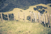 a fence line and mountainside 