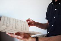 a man looking a sheet music 