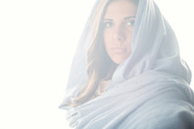 Mary in a blue shroud in bright light