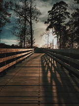 shadows and sunlight on a wood footbridge 