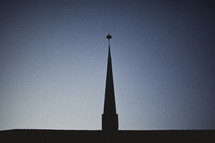 A silhouette of a church steeple