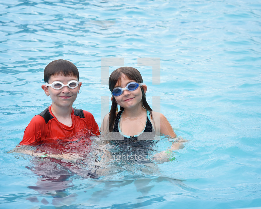 kids with goggles in a swimming pool 